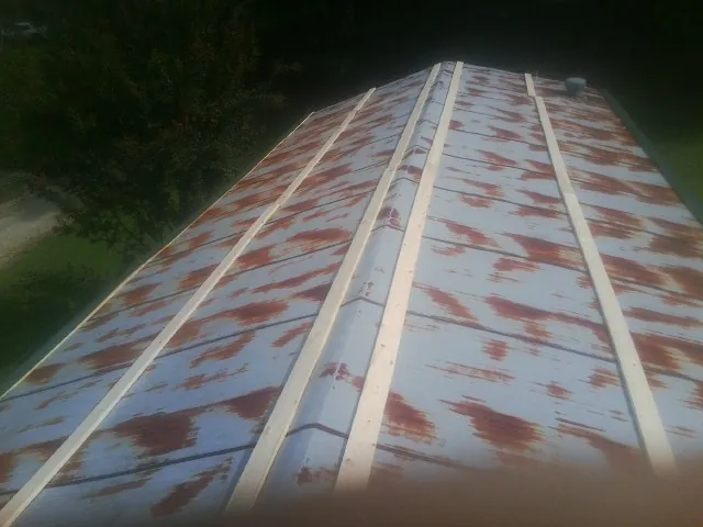 Rusted metal roof panels with new wood purlins before replacement — Storm Damage Roof Repair in Wentworth by Roofing Brothers