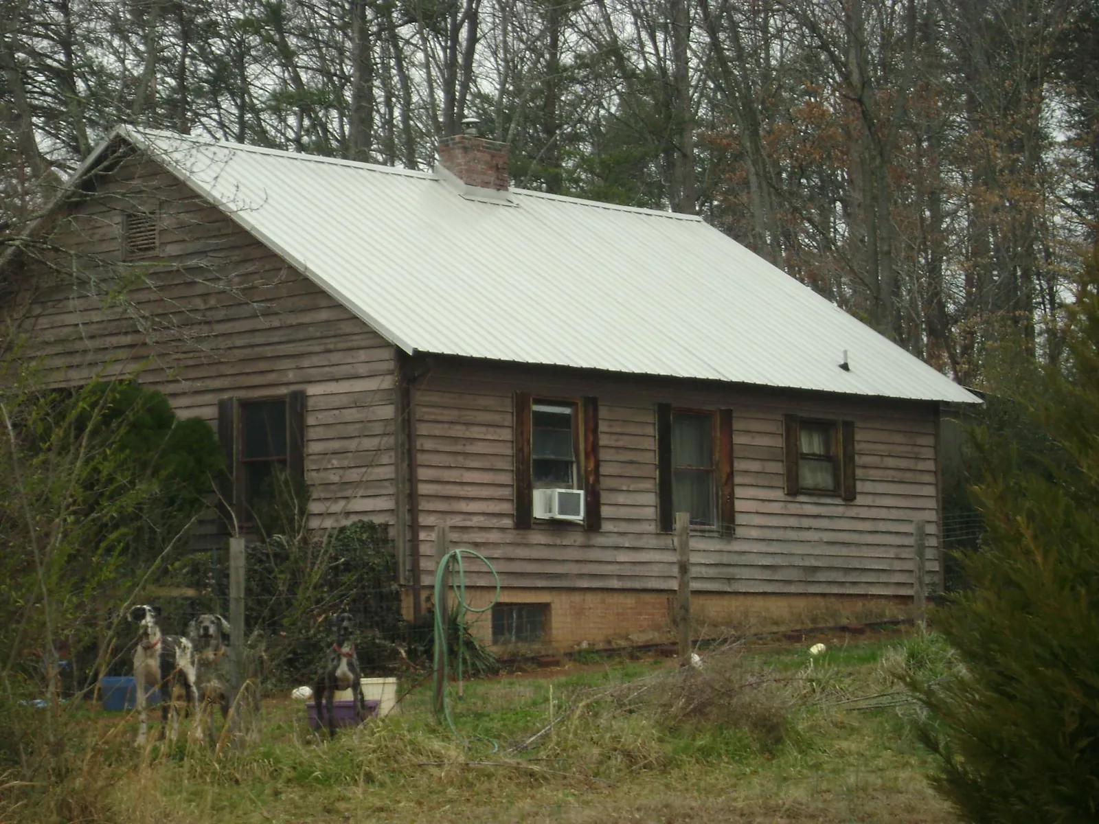White metal roof on an old wood sided farmhouse, from a Metal Roof Installation job in Wentworth